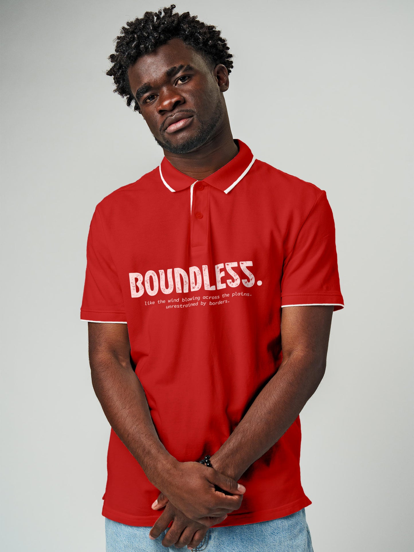 Model wearing Men's Red Polo T-shirt with 'Free & Boundless' design, offering effortless style and premium comfort