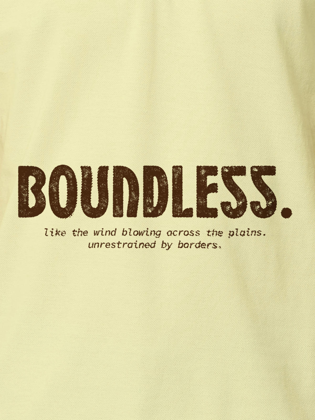 Close up of 'Free & Boundless' design on Men's Yellow Polo T-shirt, highlighting intricate details and vibrant print.