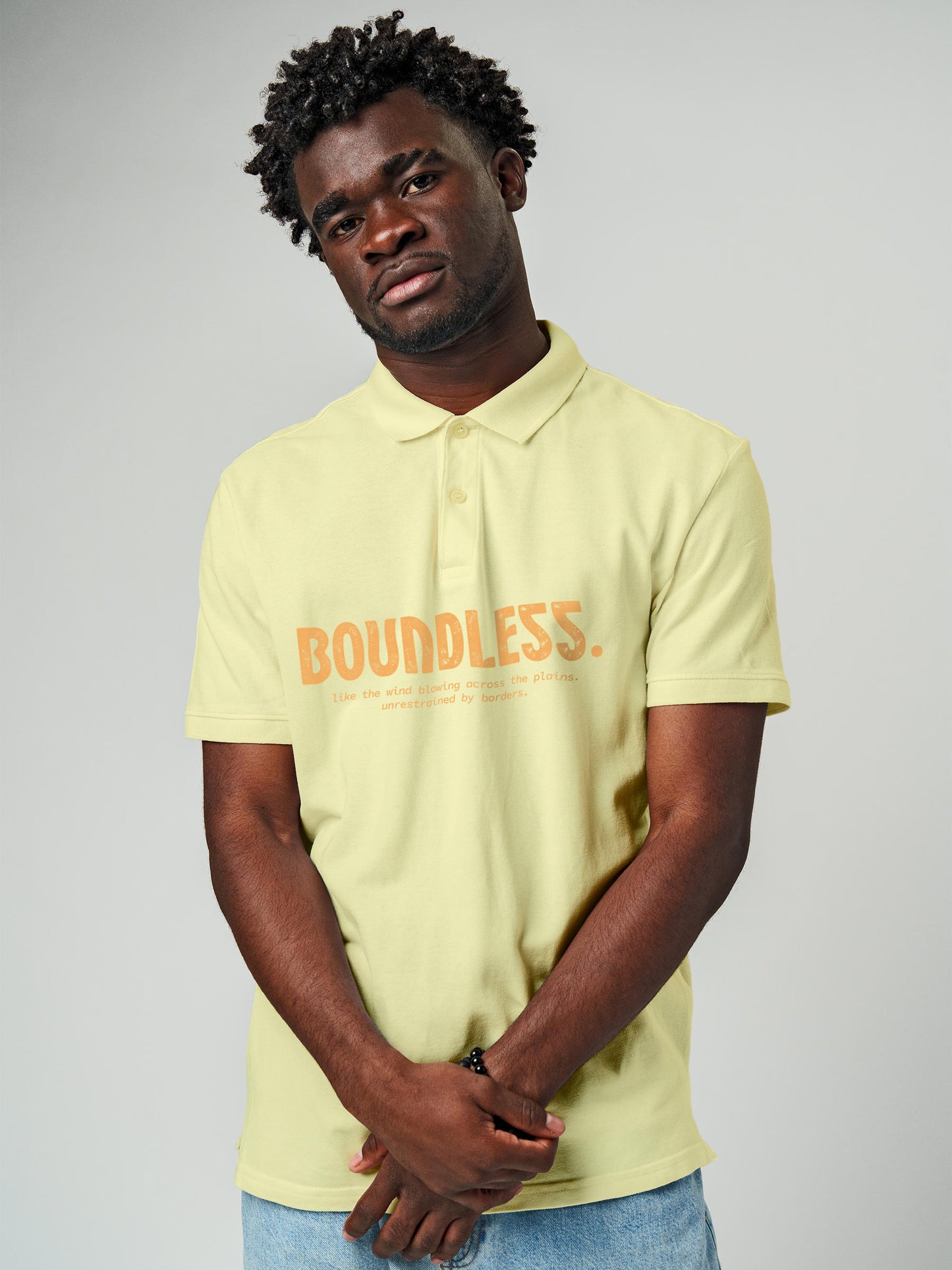 Model wearing Men's Yellow Polo T-shirt with 'Free & Boundless' design, offering effortless style and premium comfort