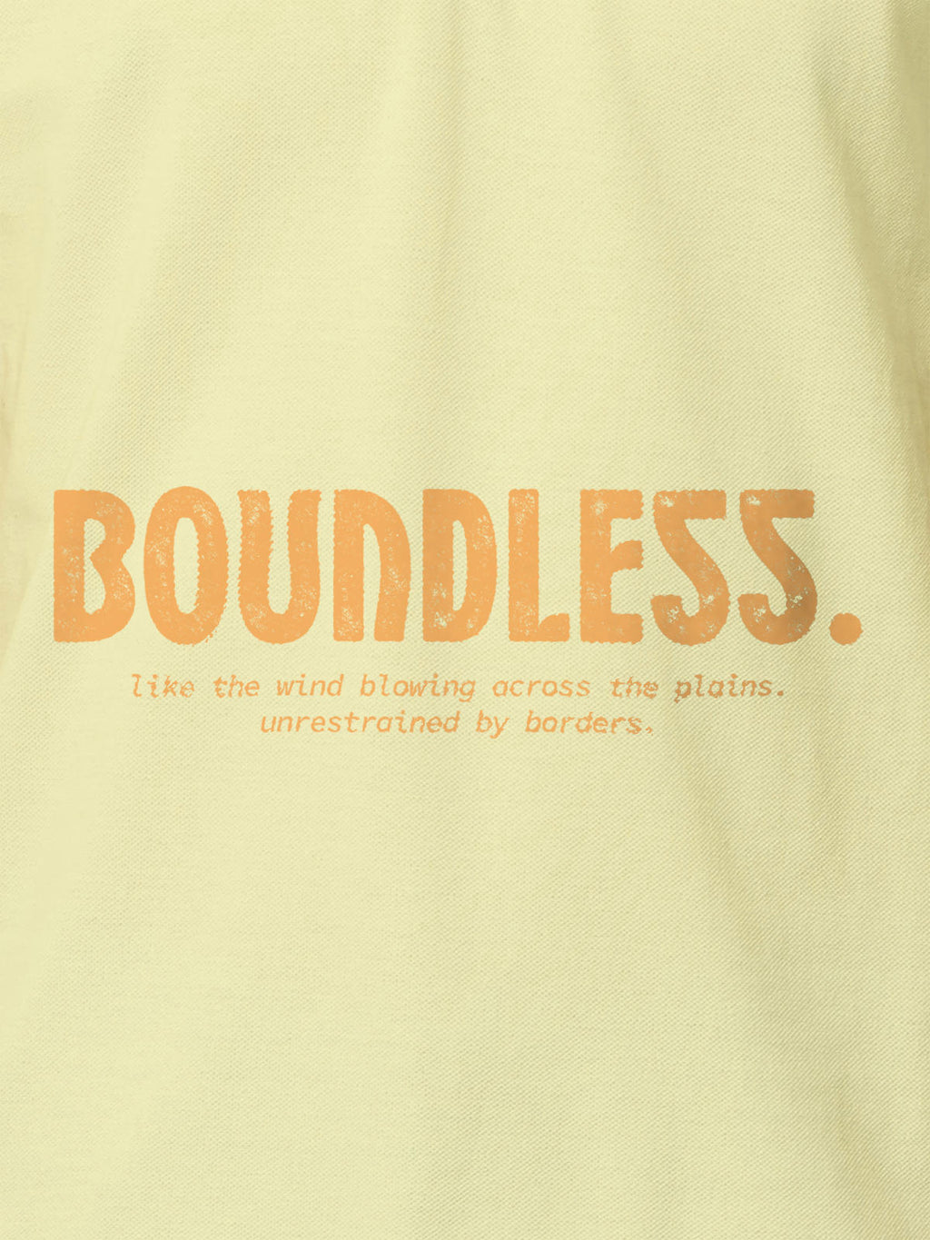 Close up of 'Free & Boundless' design on Men's Yellow Polo T-shirt, highlighting intricate details and vibrant print.