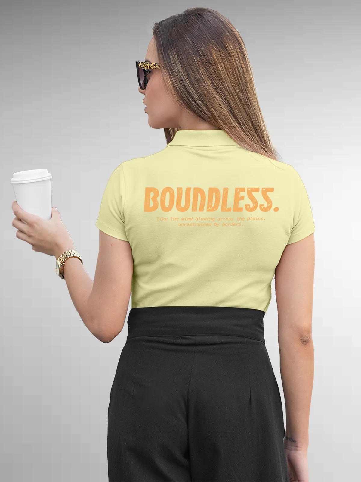Model wearing Women's Yellow Collar T-shirt with a big, bold 'Boundless' design printed on the back, along with an insiprational text