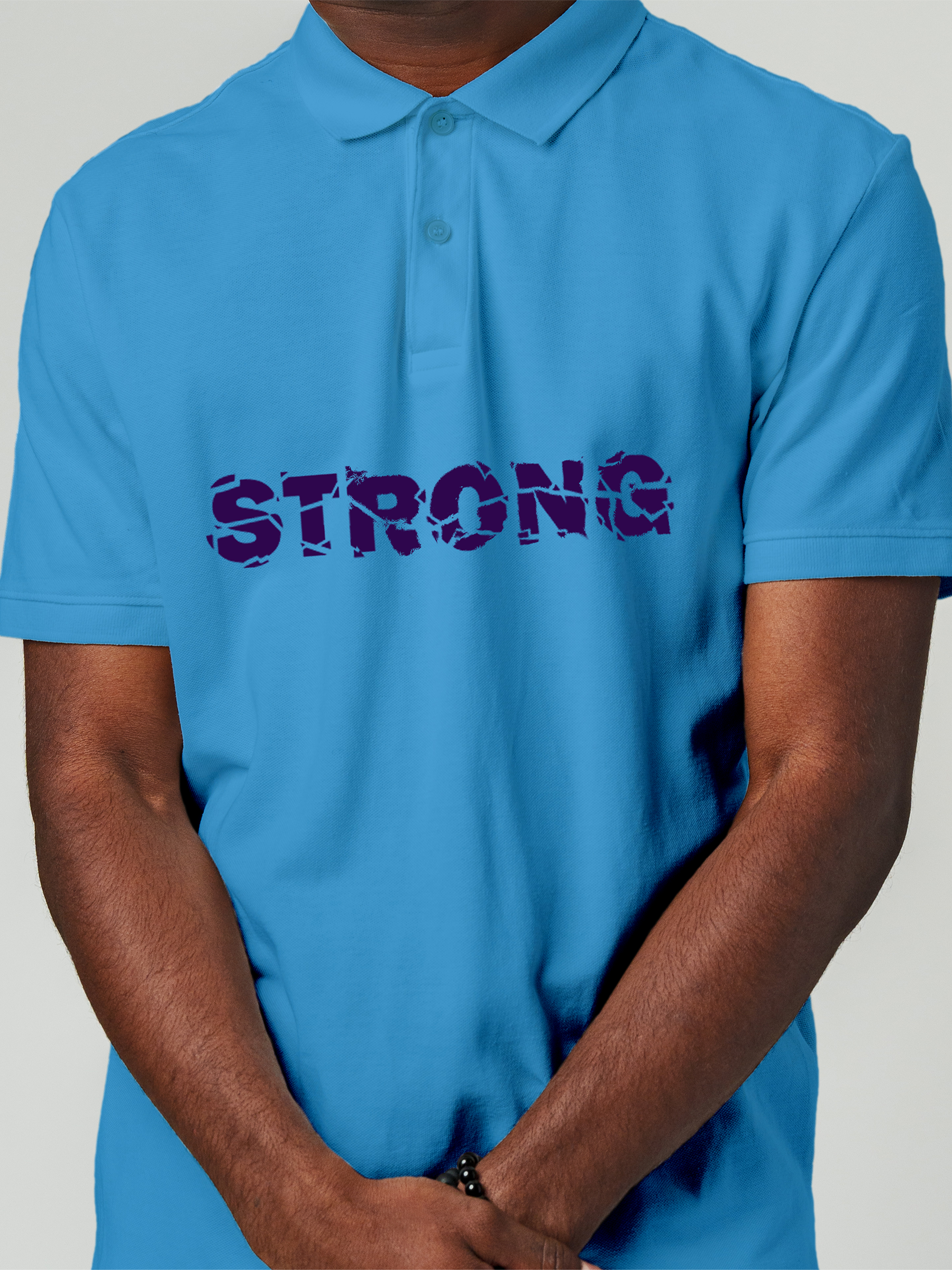 Close up of 'Strong' design on Men's Blue Polo T-shirt, highlighting intricate details and vibrant print.