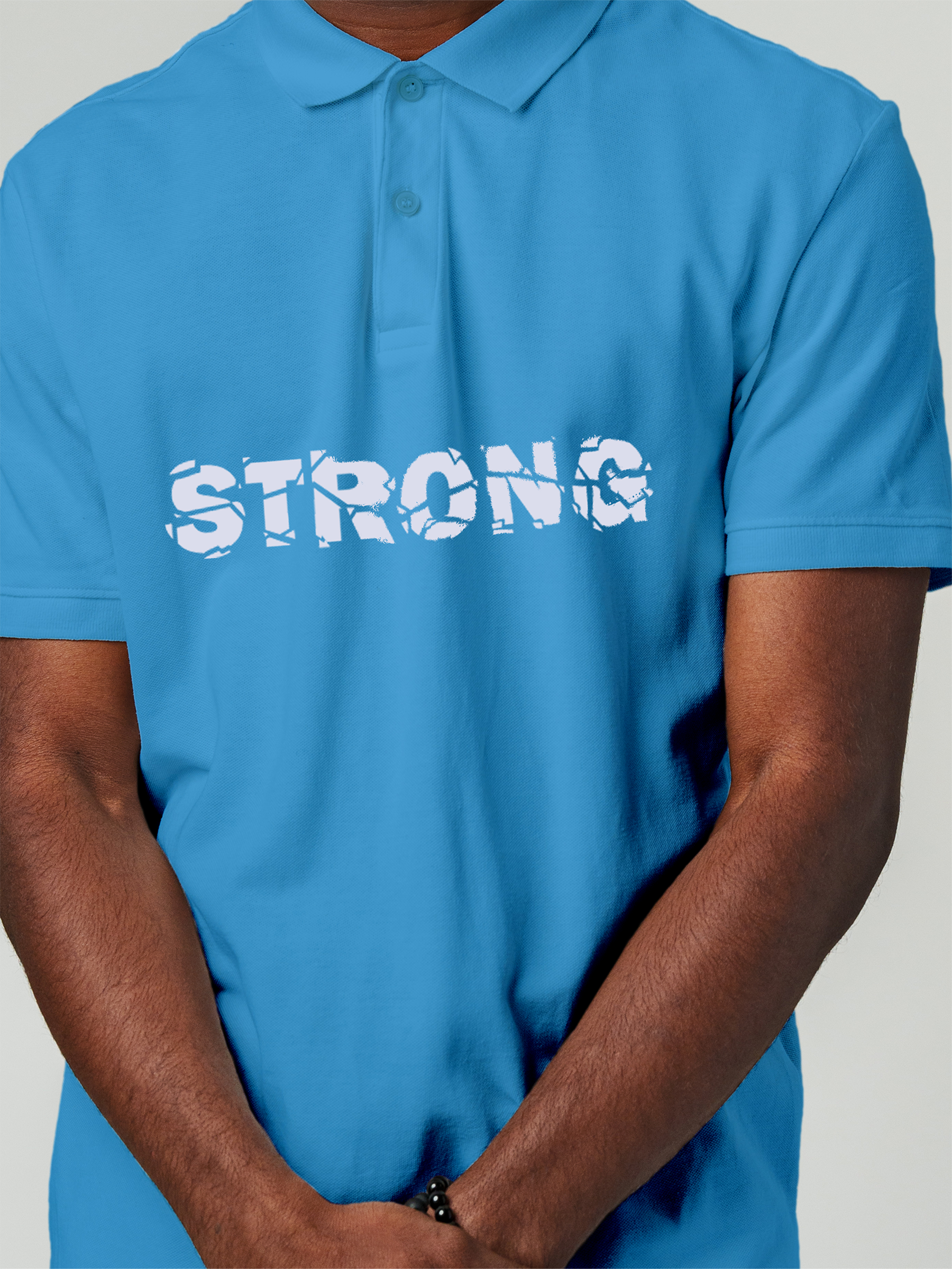 Close up of 'Strong' design on Men's Blue Polo T-shirt, highlighting intricate details and vibrant print.
