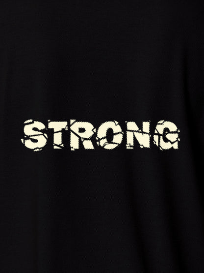 Close up of 'Strong' design on Men's Black Polo T-shirt, highlighting intricate details and vibrant print.
