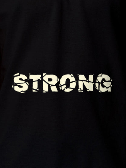 Close up of 'Strong' design on Women's Black Polo T-shirt, highlighting intricate details and vibrant print.
