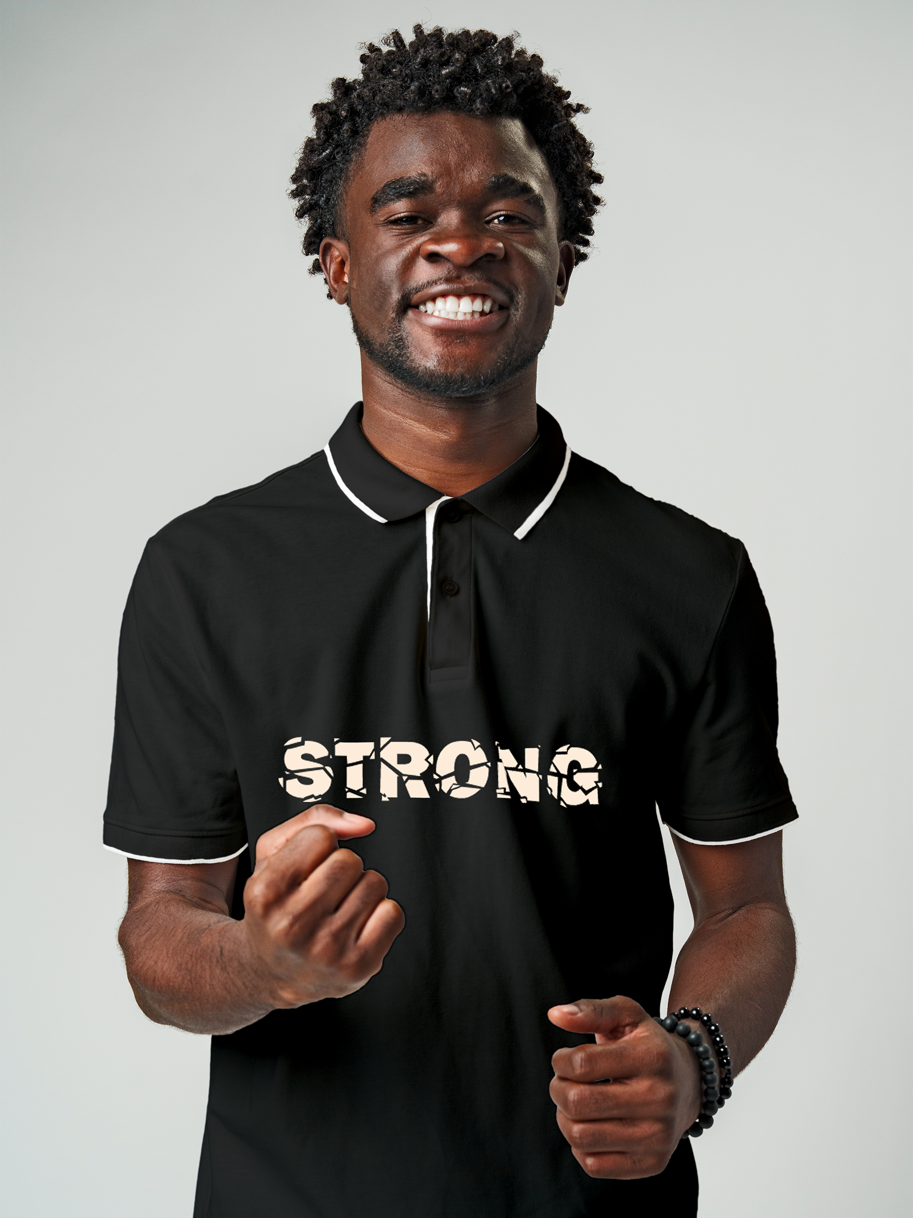 Model wearing Men's Charcoal Grey Polo T-shirt with 'Strong' design, offering effortless style and premium comfort