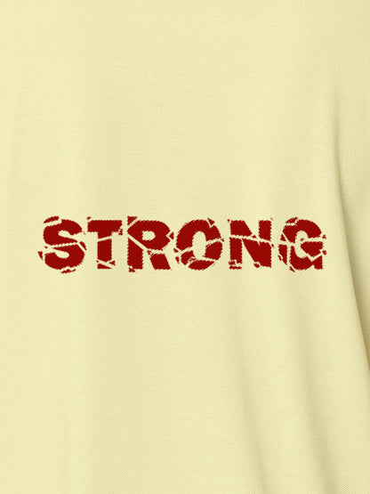Close up of 'Strong' design on Men's Yellow Polo T-shirt, highlighting intricate details and vibrant print.