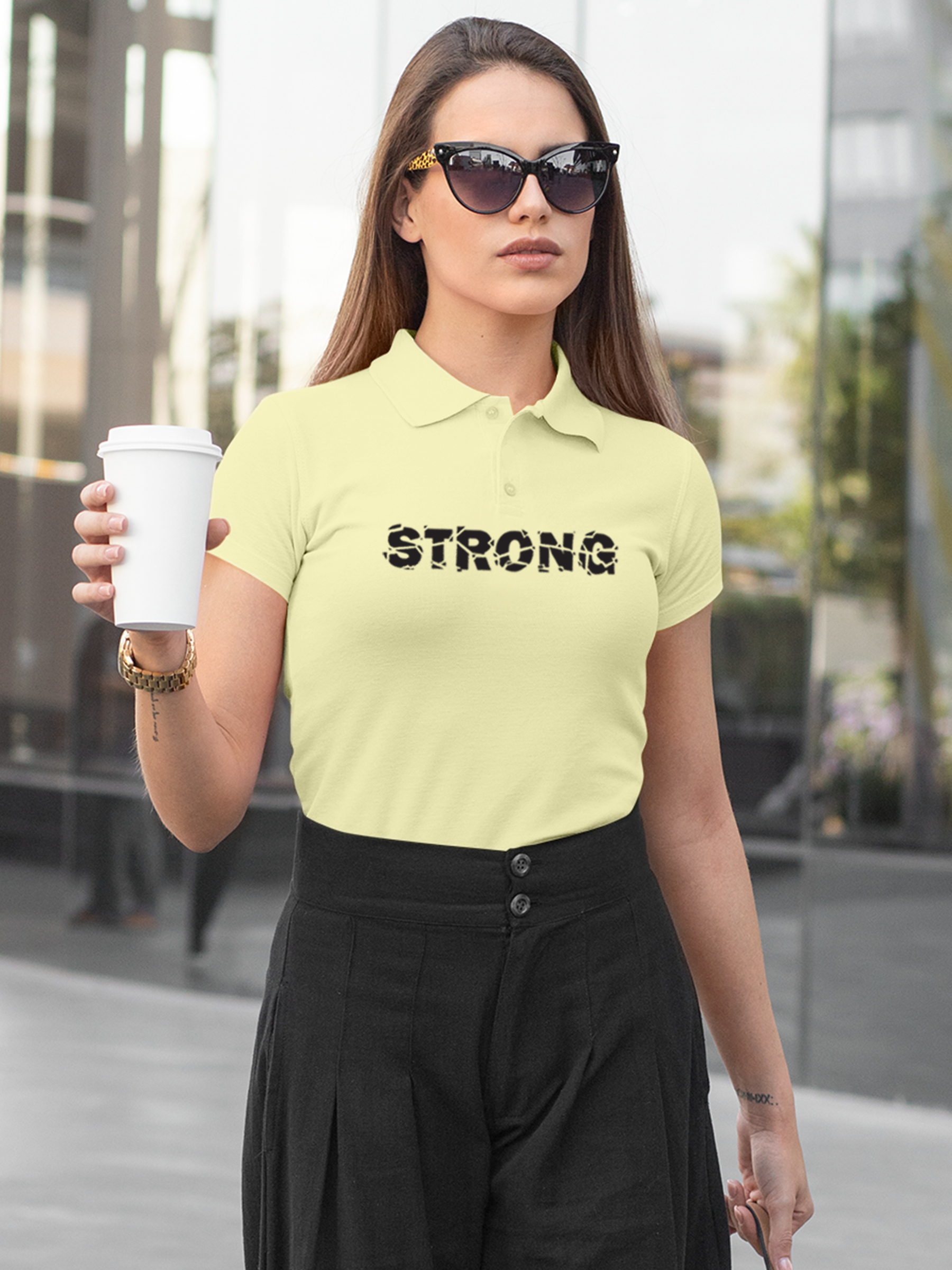 Model wearing Women's Yellow Polo T-shirt with 'Strong' design, offering effortless style and premium comfort