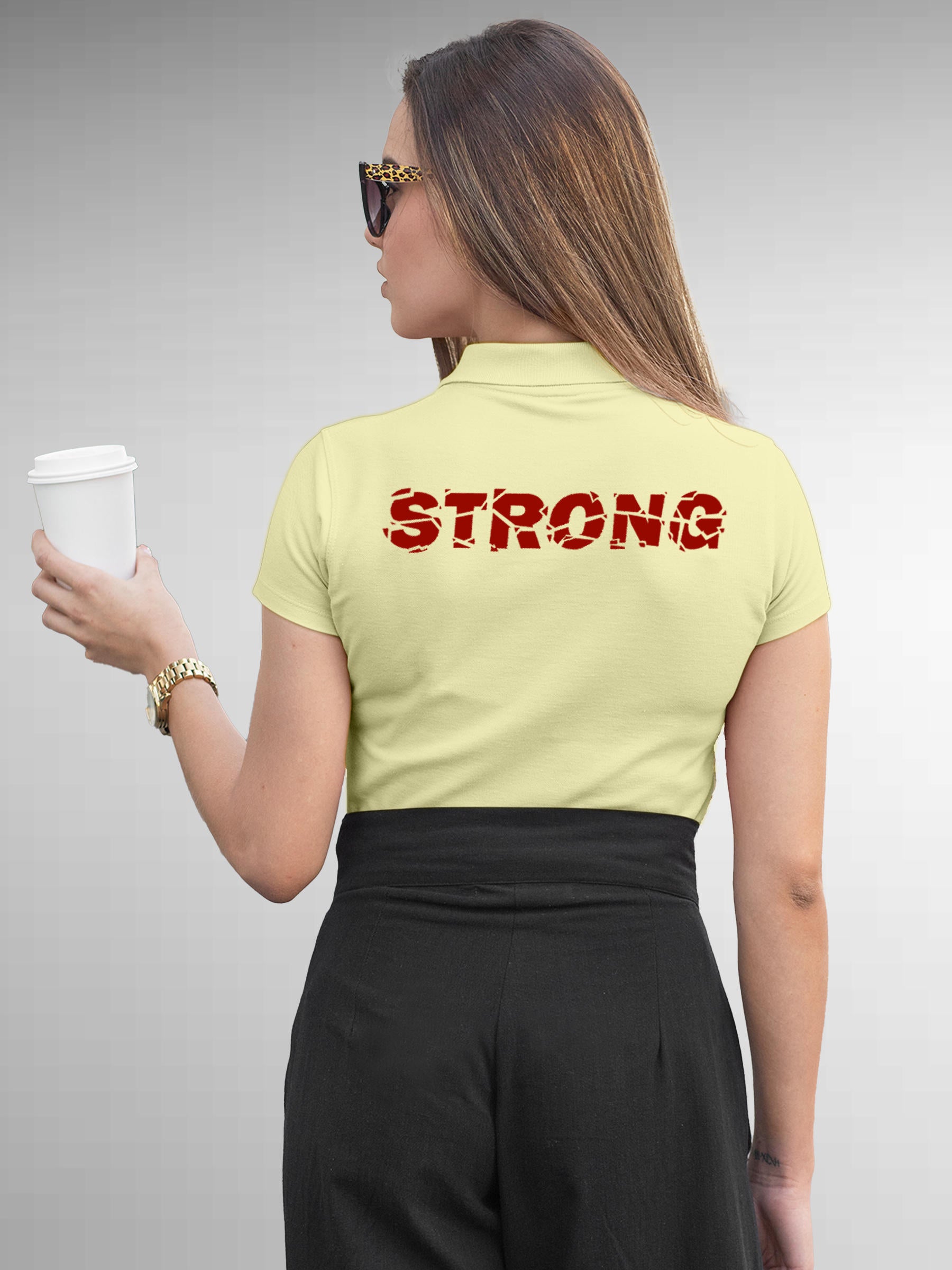 Model wearing Women's Yellow Polo T-shirt with 'Strong' design, offering effortless style and premium comfort