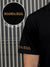 Close up of 'Boundless' print on the sleeve of Men's Black Collar T-shirt, highlighting the vibrant print.