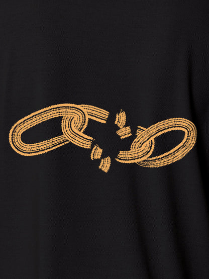 Close up of 'Boundless' design on Women's Dark Grey Polo T-shirt, highlighting intricate details and vibrant print.