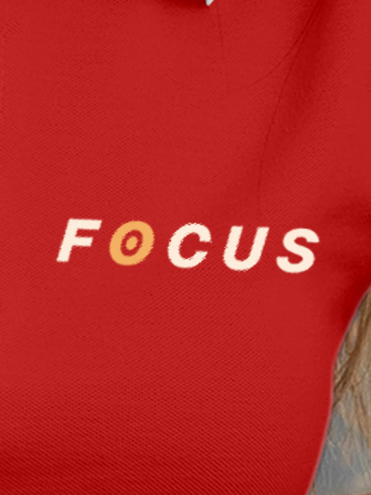 Close up of 'Focus' design on Women's Red Collar T-shirt, highlighting intricate details and vibrant print.