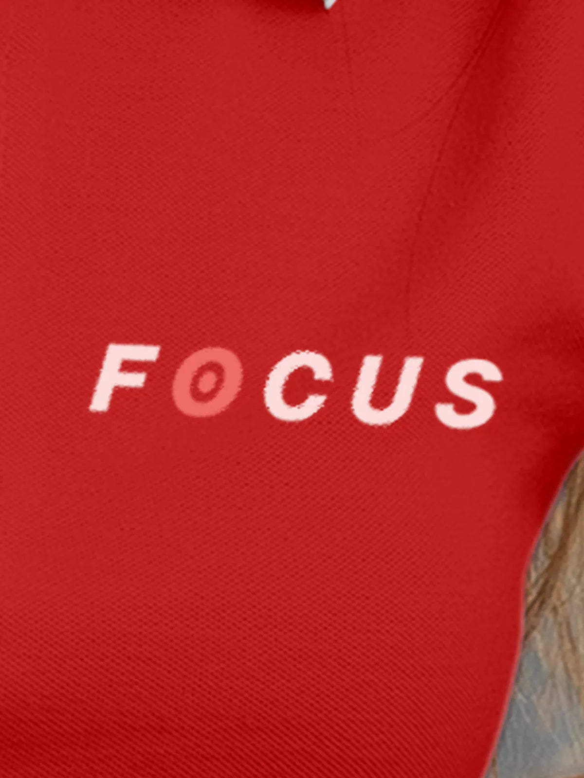 Close up of 'Focus' design on Women's Red Collar T-shirt, highlighting intricate details and vibrant print.