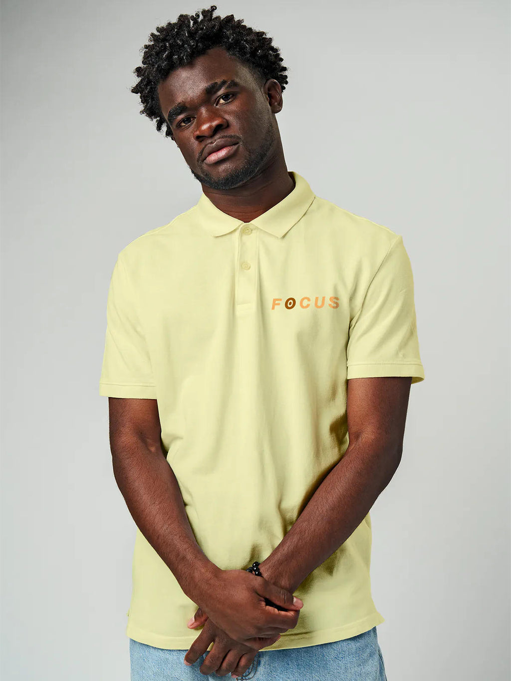 Close up of 'Focus' design on Men's Yellow Collar T-shirt, highlighting intricate details and vibrant print.
