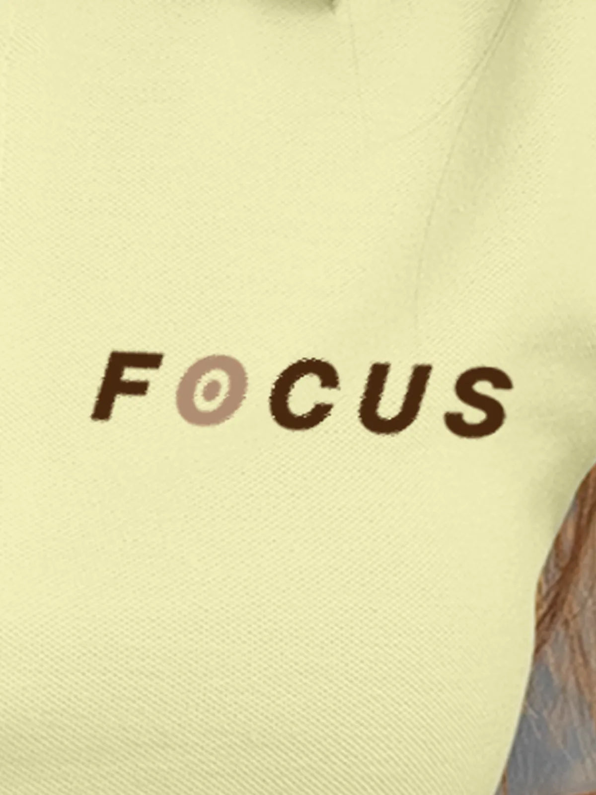 Close up of 'Focus' design on Women's Yellow Collar T-shirt, highlighting intricate details and vibrant print.