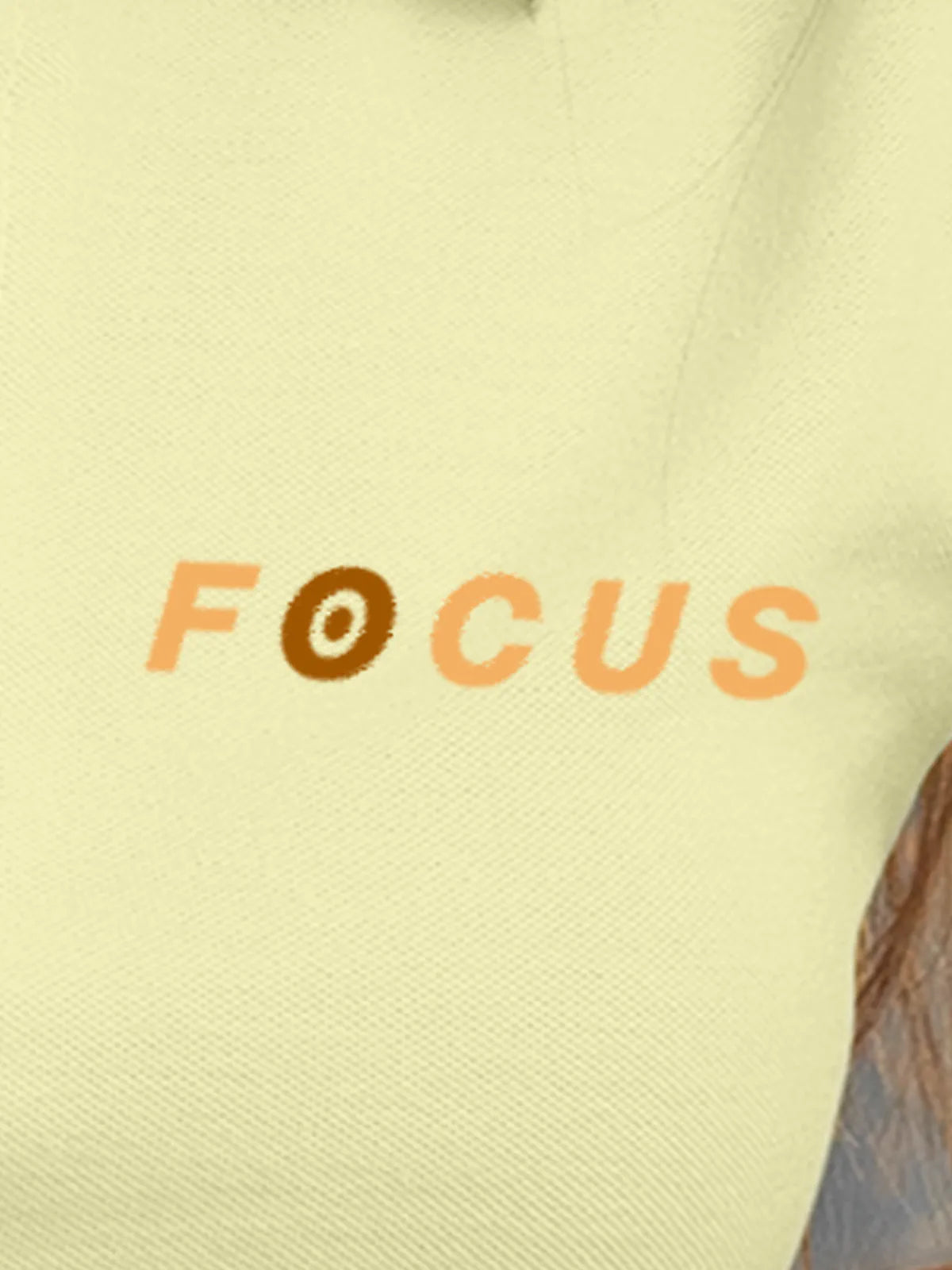 Close up of 'Focus' design on Women's Yellow Collar T-shirt, highlighting intricate details and vibrant print.