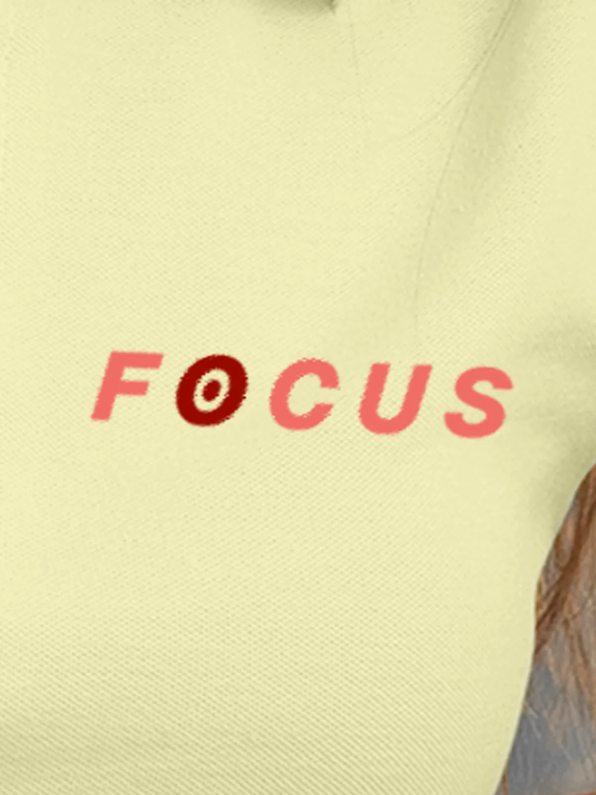 Close up of 'Focus' design on Women's Yellow Collar T-shirt, highlighting intricate details and vibrant print.
