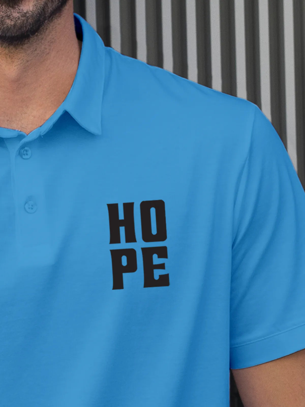 Close up of 'Hope' on Men's Blue Polo T-shirt, highlighting intricate details and vibrant print.