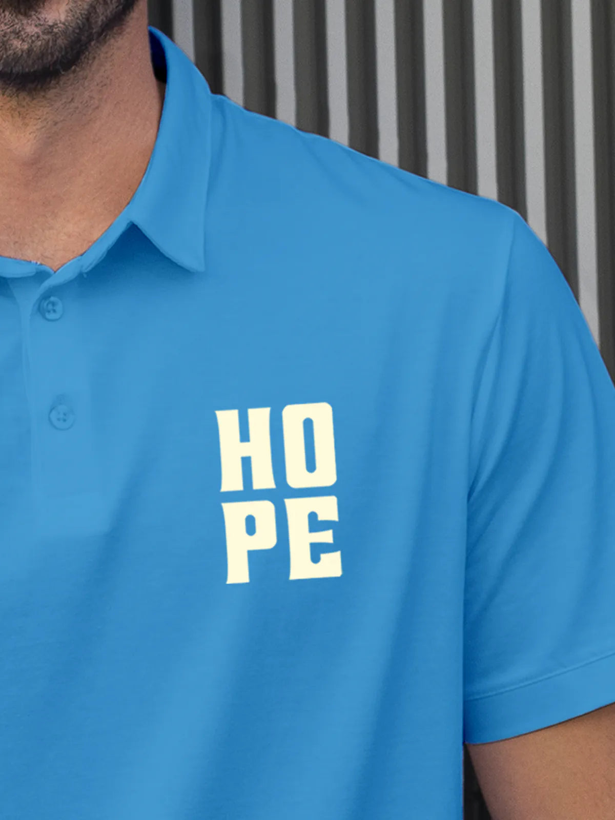 Close up of 'Hope' on Men's Blue Polo T-shirt, highlighting intricate details and vibrant print.