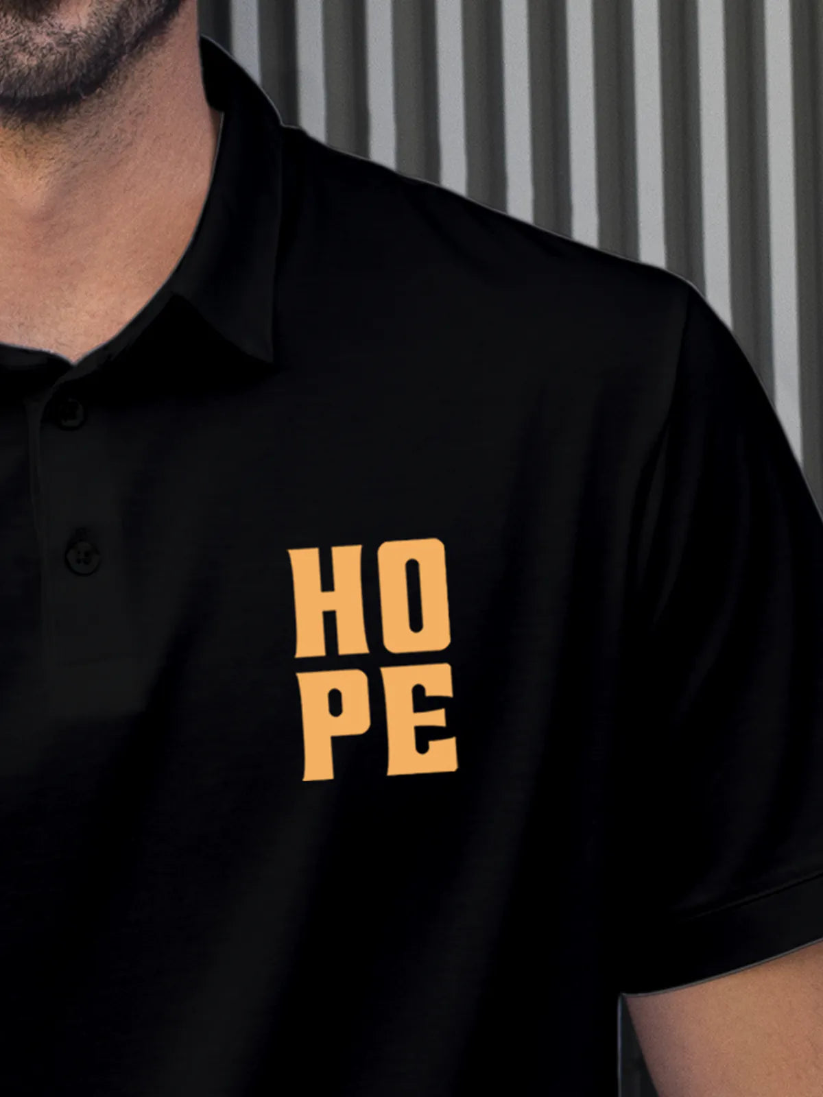 Close up of 'Hope' on Men's Black Polo T-shirt, highlighting intricate details and vibrant print.