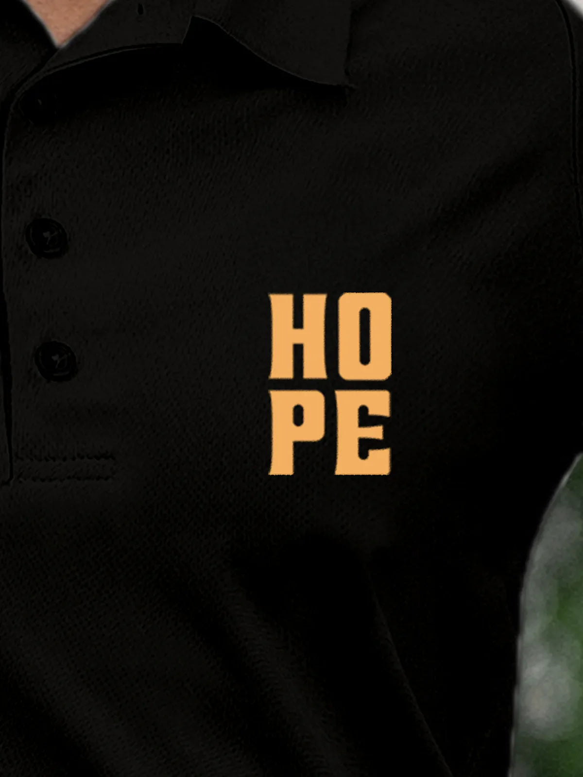 Close up of 'Hope' on Women's Black Polo T-shirt, highlighting intricate details and vibrant print.