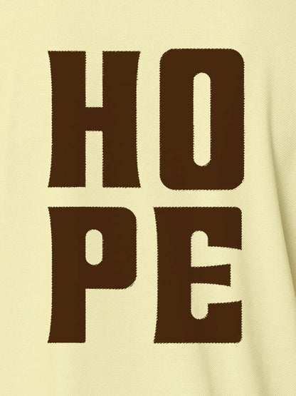 Close up of 'Hope' design on Men's Yellow Polo T-shirt, highlighting intricate details and vibrant print.