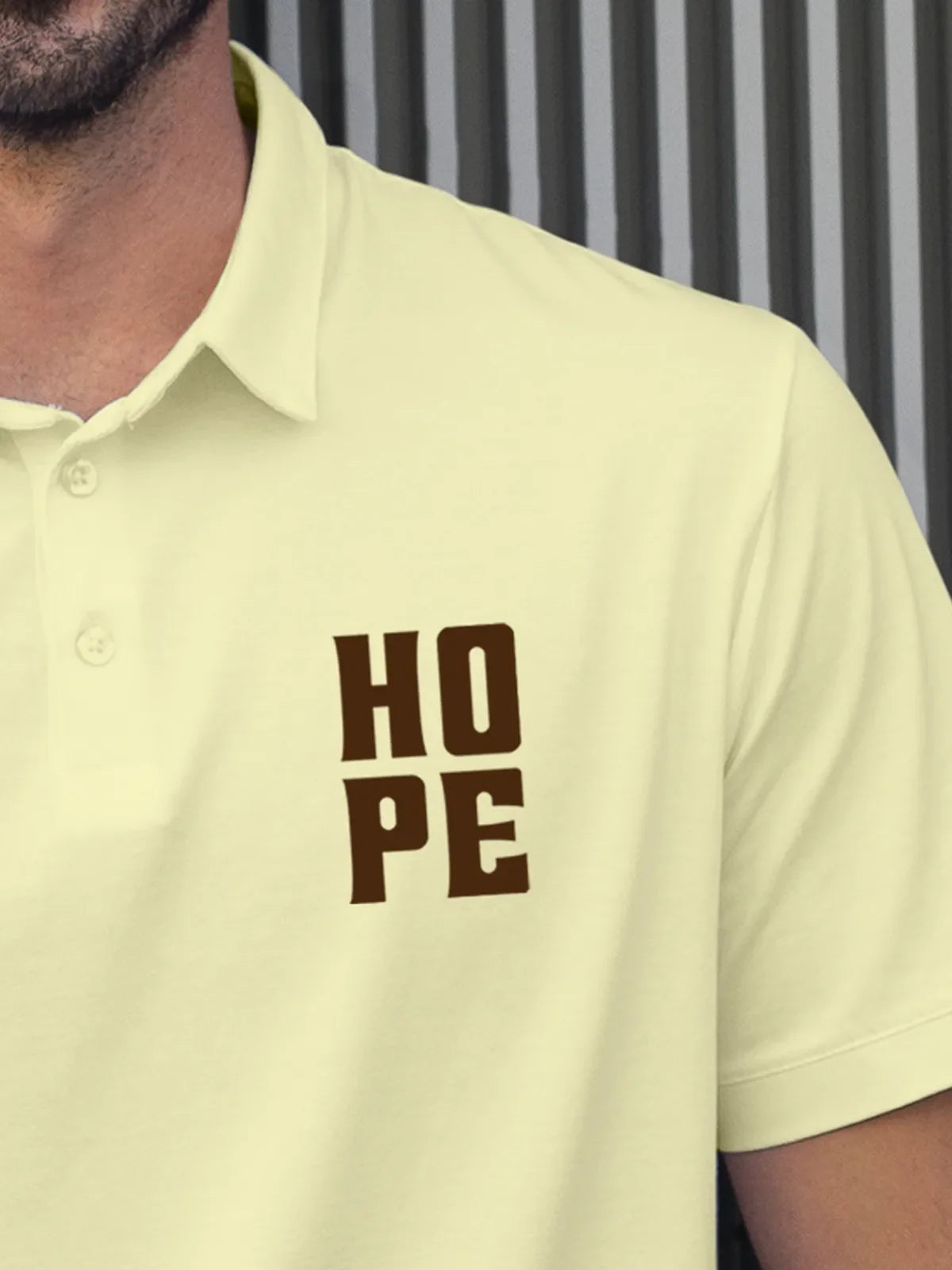Close up of 'Hope' on Men's Yellow Polo T-shirt, highlighting intricate details and vibrant print.