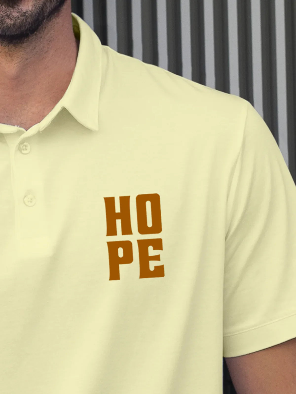 Close up of 'Hope' on Men's Yellow Polo T-shirt, highlighting intricate details and vibrant print.