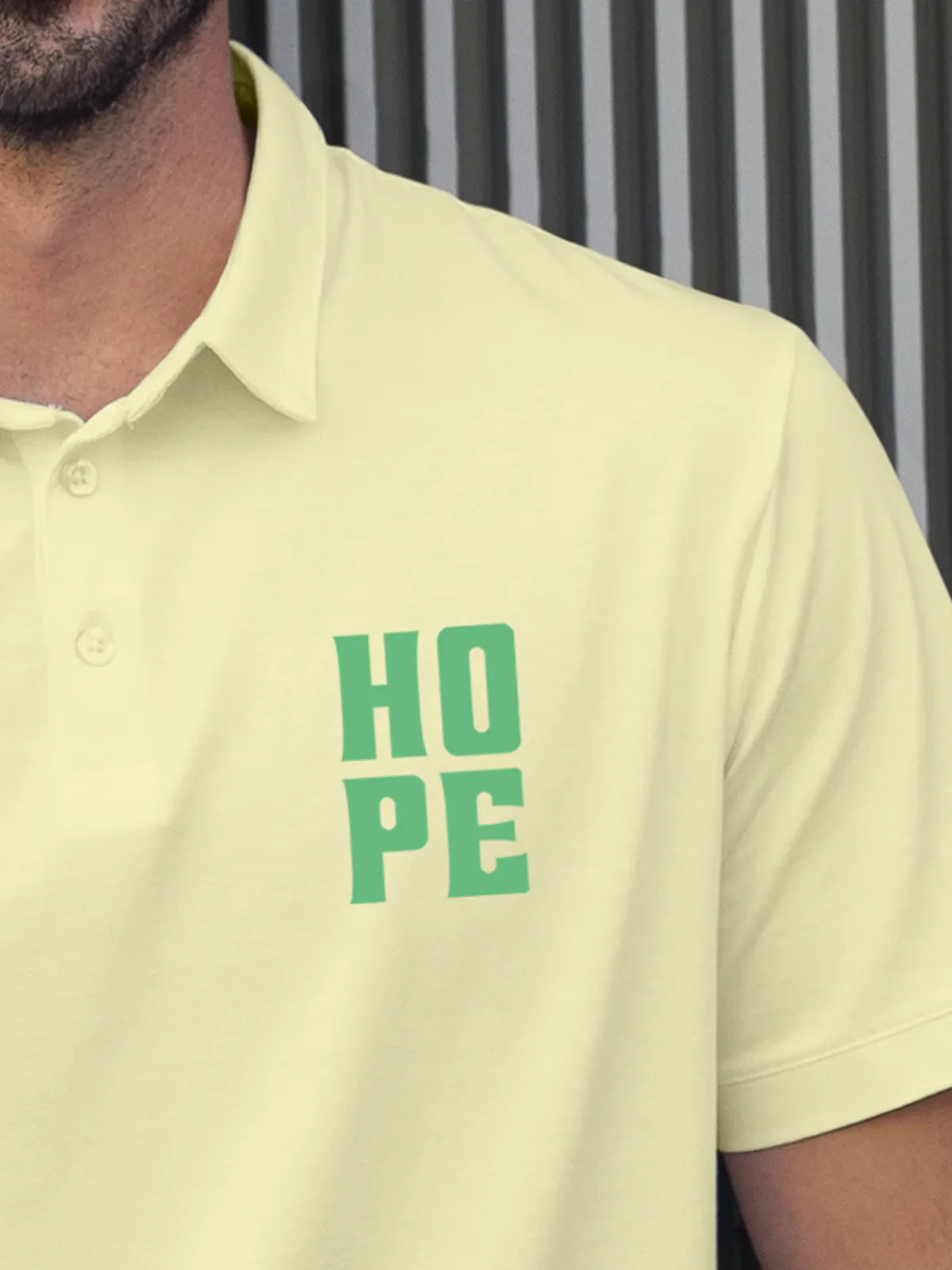 Close up of 'Hope' on Men's Yellow Polo T-shirt, highlighting intricate details and vibrant print.
