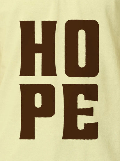 Close up of 'Hope' design on Women's Yellow Polo T-shirt, highlighting intricate details and vibrant print.