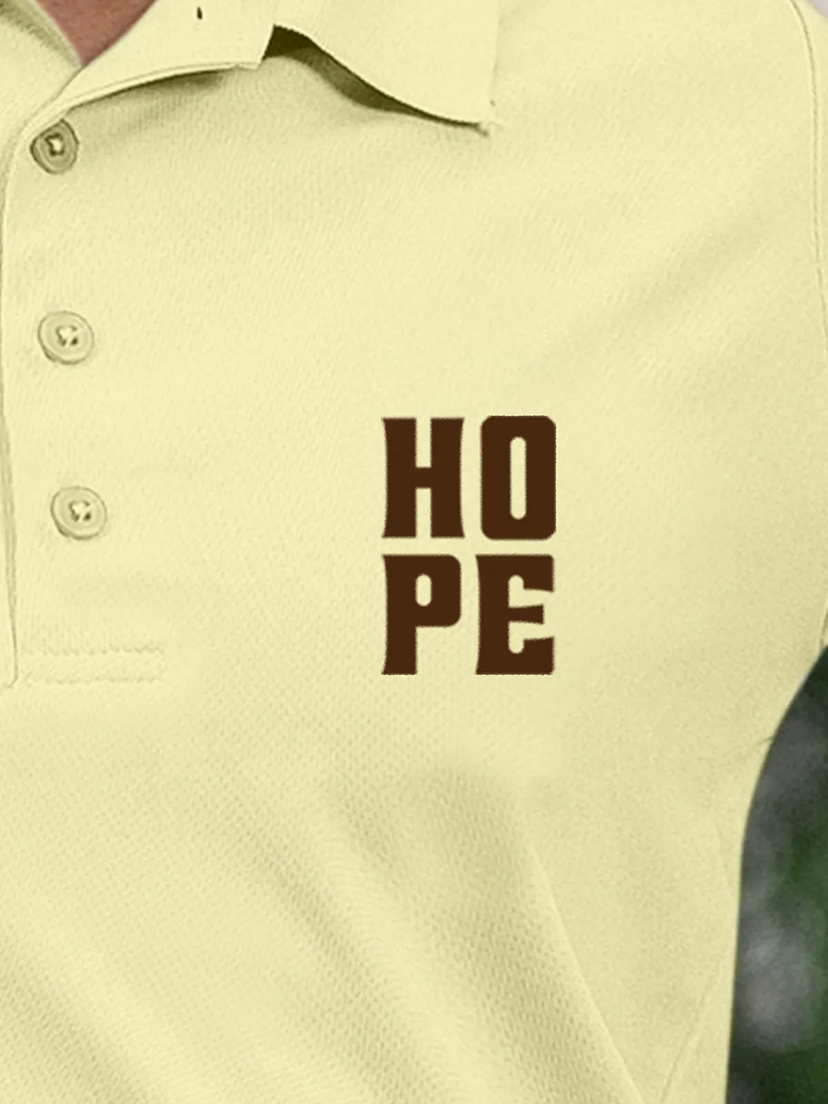Close up of 'Hope' on Women's Yellow Polo T-shirt, highlighting intricate details and vibrant print.