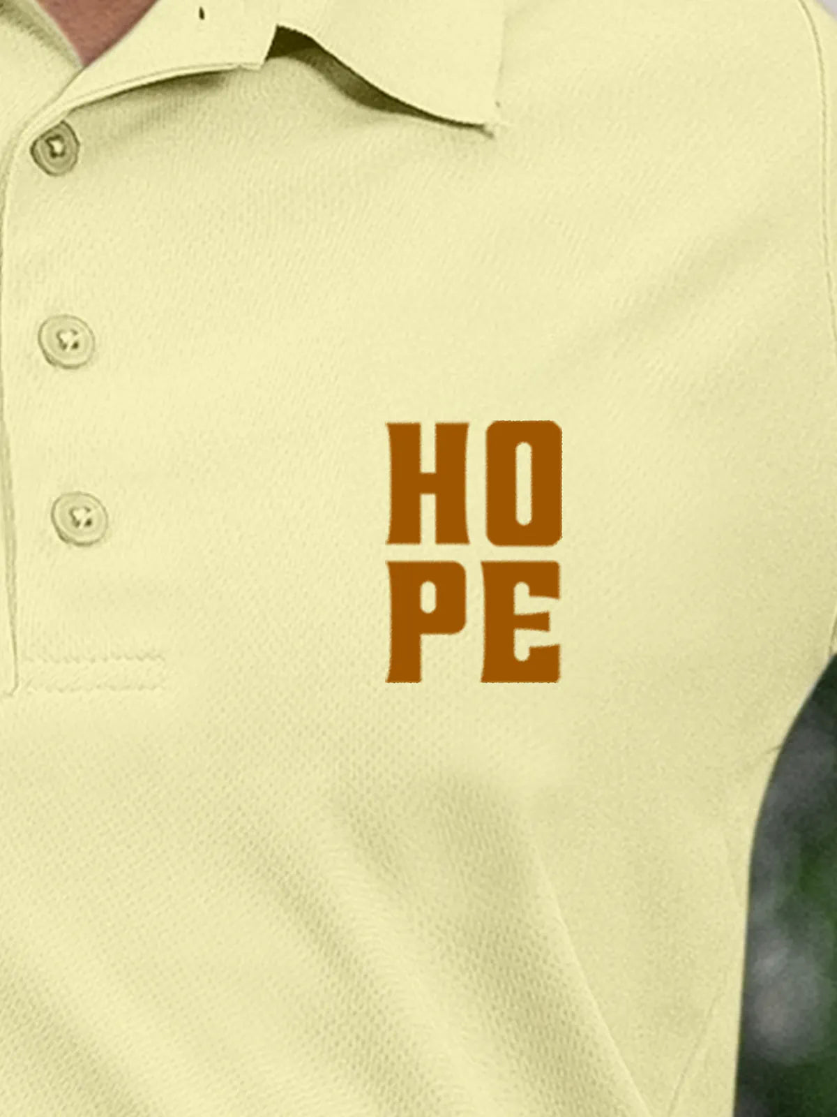 Close up of 'Hope' on Women's Yellow Polo T-shirt, highlighting intricate details and vibrant print.