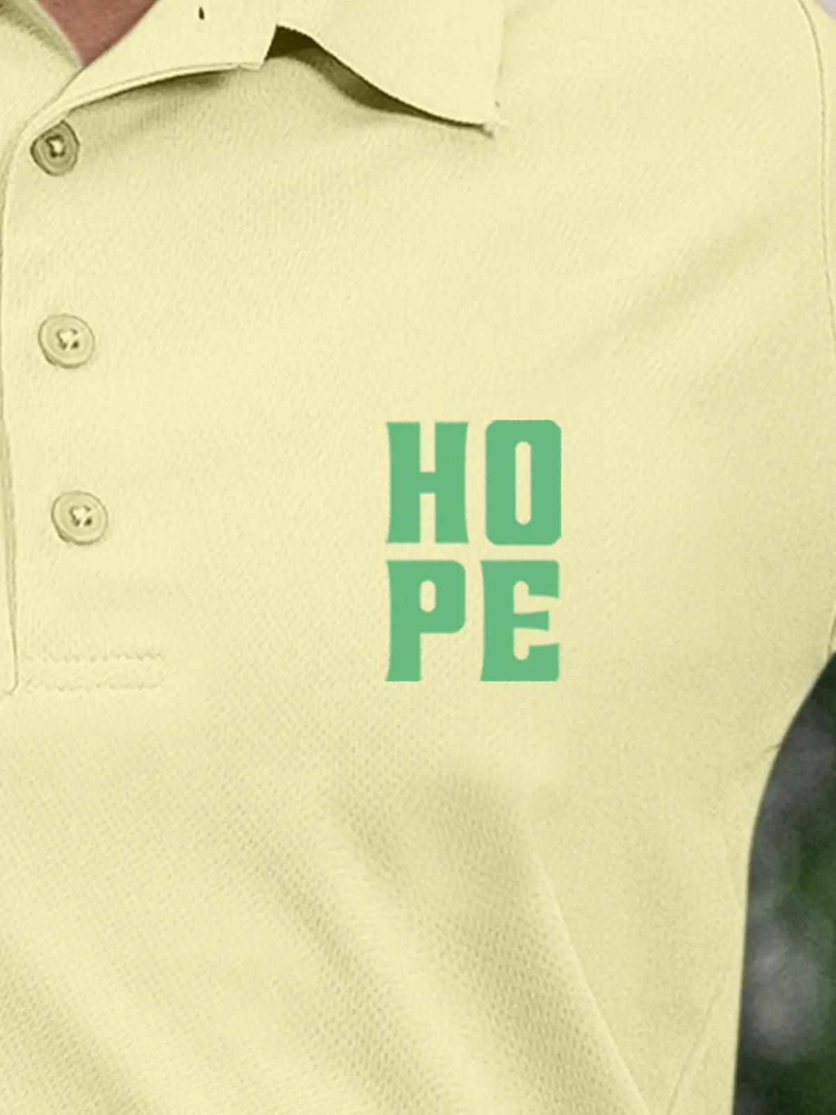 Close up of 'Hope' on Women's Yellow Polo T-shirt, highlighting intricate details and vibrant print.