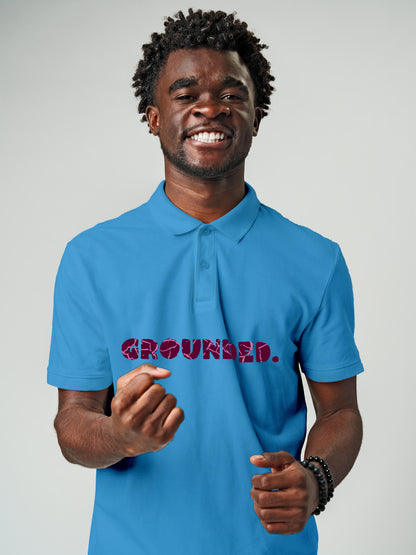 Model wearing Men's Blue Polo T-shirt with 'Grounded' design, offering effortless style and premium comfort