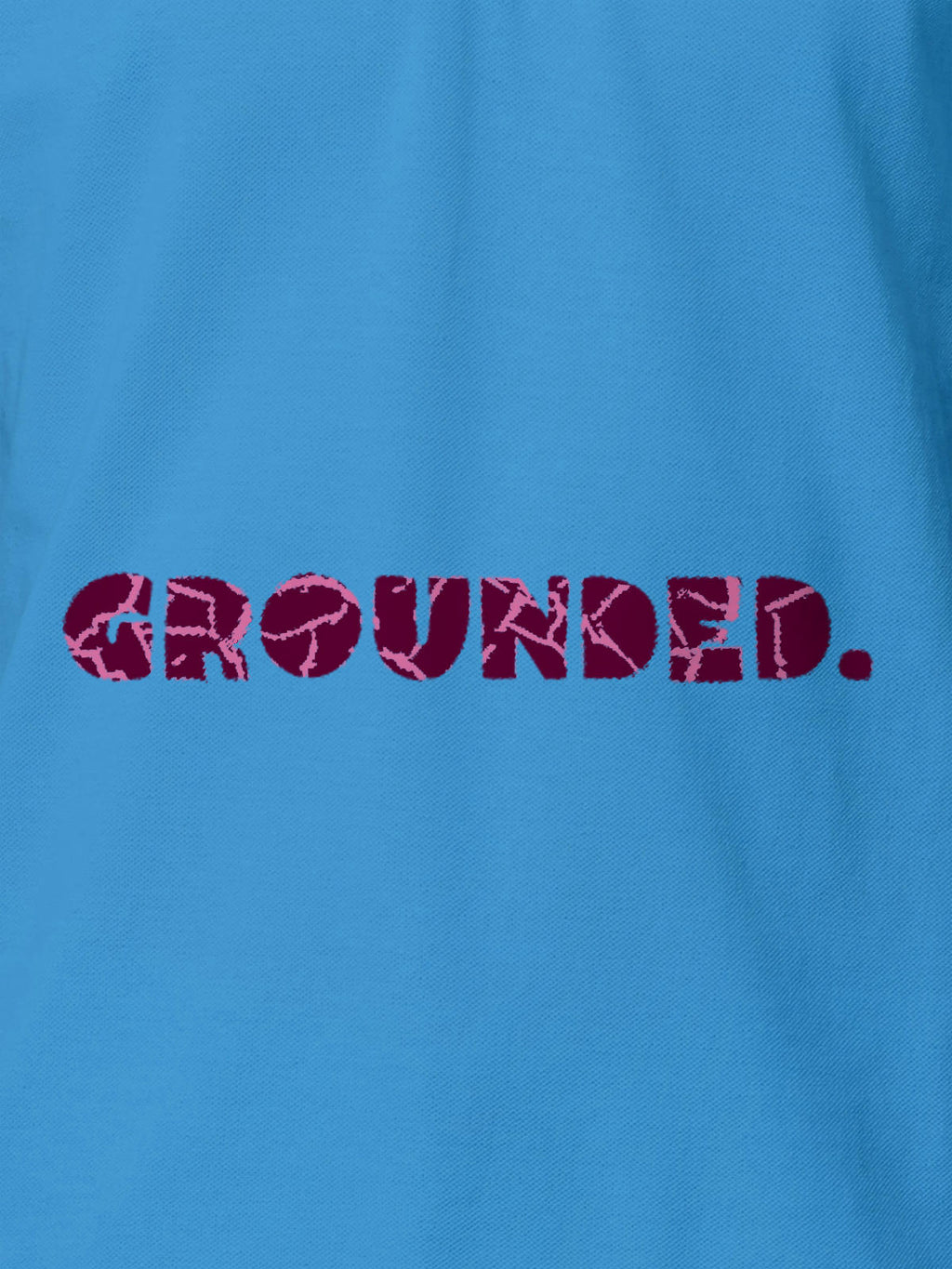 Close up of 'Grounded' design on Men's Blue Polo T-shirt, highlighting intricate details and vibrant print.