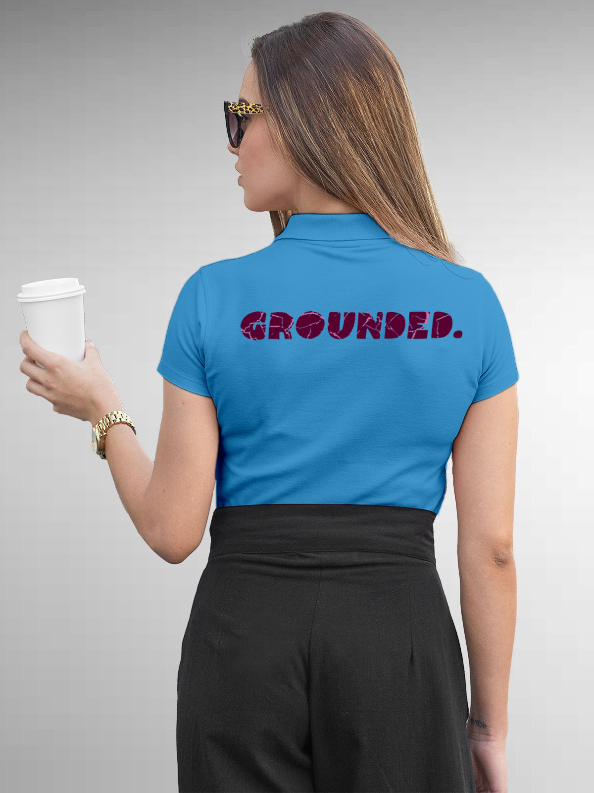 Model wearing Women's Blue Polo T-shirt with 'Grounded' design, offering effortless style and premium comfort