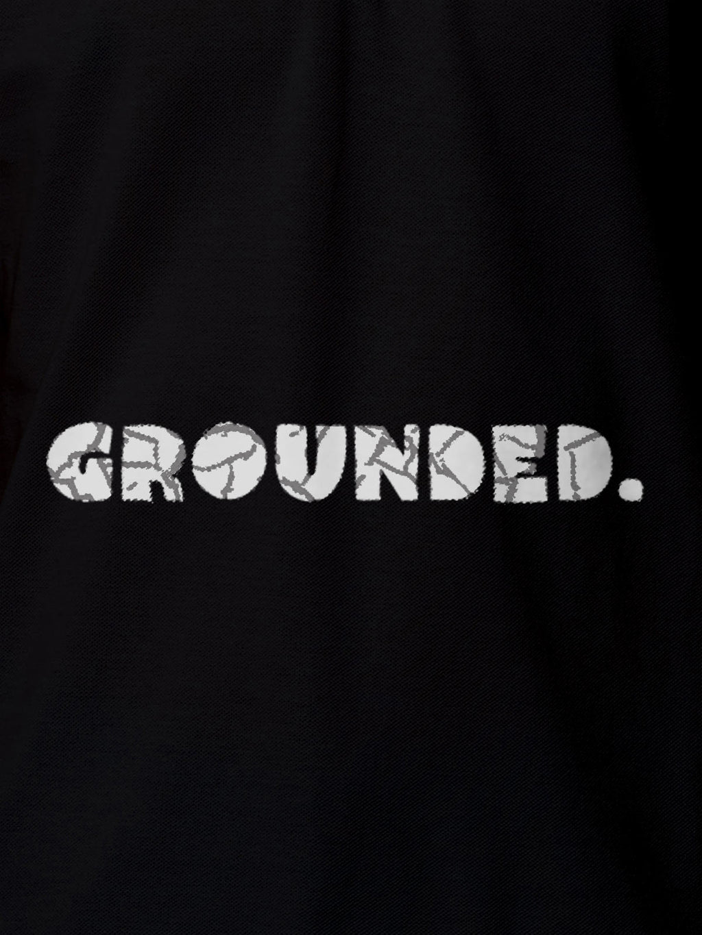 Close up of 'Grounded' design on Men's Black Polo T-shirt, highlighting intricate details and vibrant print.