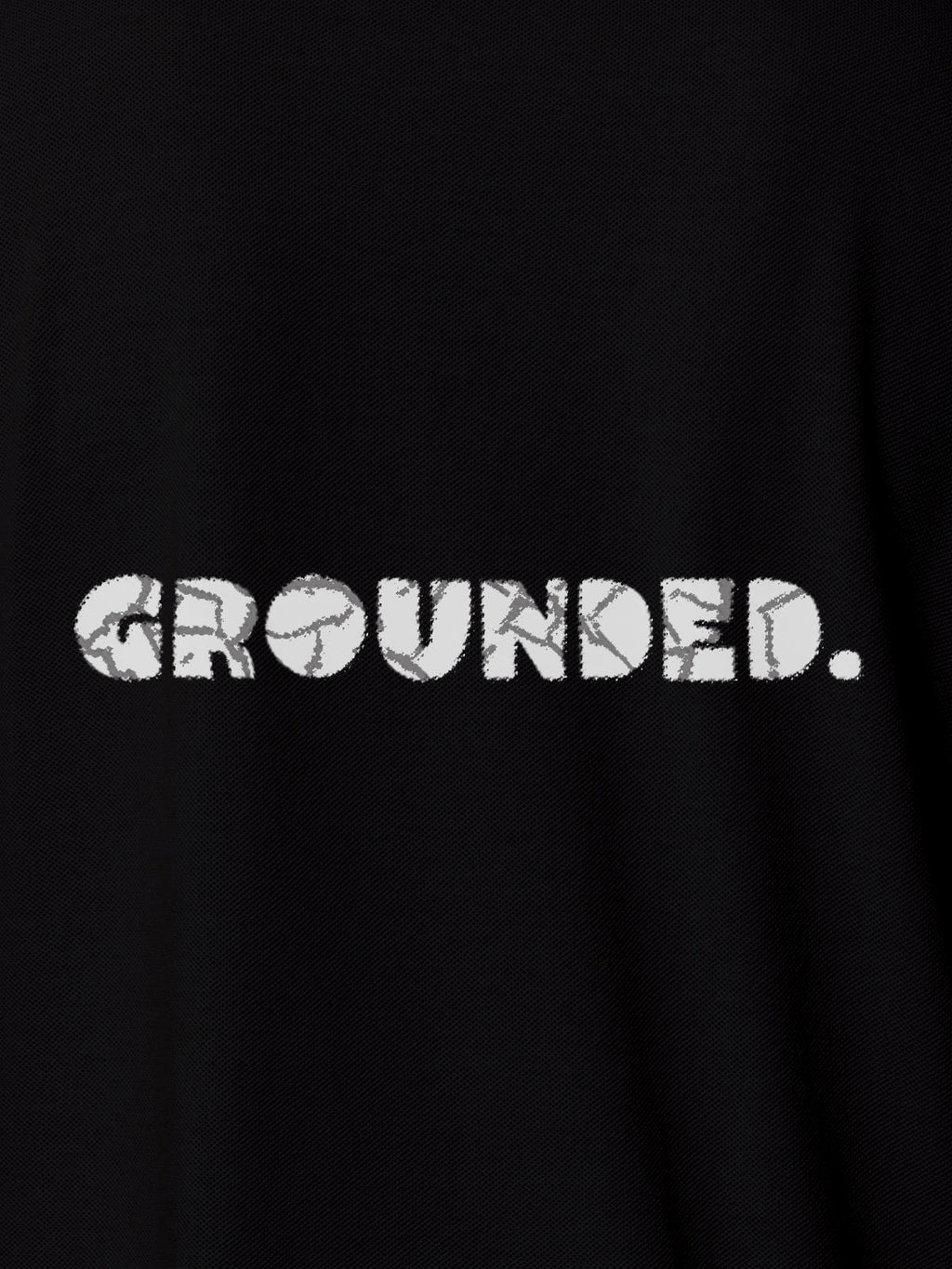 Close up of 'Grounded' design on Women's Black Polo T-shirt, highlighting intricate details and vibrant print.