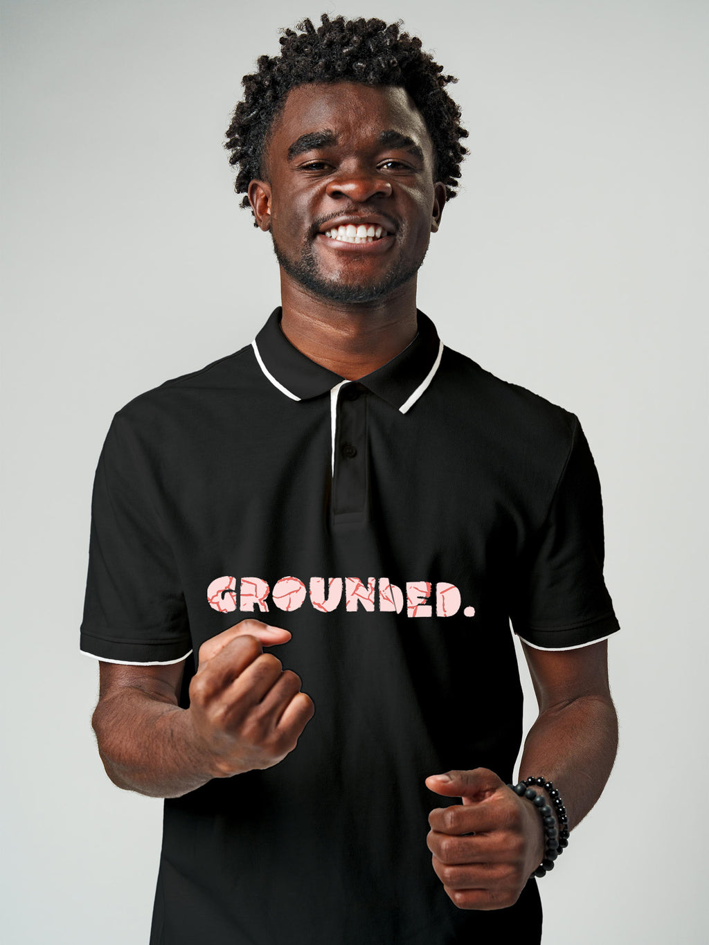 Model wearing Men's Dark Grey Polo T-shirt with 'Grounded' design, offering effortless style and premium comfort