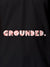 Close up of 'Grounded' design on Men's Dark Grey Polo T-shirt, highlighting intricate details and vibrant print.
