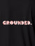 Close up of 'Grounded' design on Women's Dark Grey Polo T-shirt, highlighting intricate details and vibrant print.