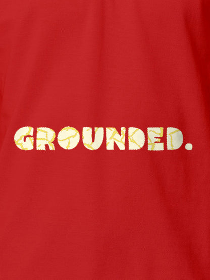Close up of 'Grounded' design on Men's Red Polo T-shirt, highlighting intricate details and vibrant print.