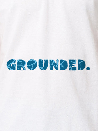 Close up of 'Grounded' design on Men's White Polo T-shirt, highlighting intricate details and vibrant print.