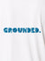Close up of 'Grounded' design on Women's White Polo T-shirt, highlighting intricate details and vibrant print.