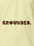Close up of 'Grounded' design on Men's Yellow Polo T-shirt, highlighting intricate details and vibrant print.