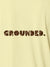 Close up of 'Grounded' design on Women's Yellow Polo T-shirt, highlighting intricate details and vibrant print.