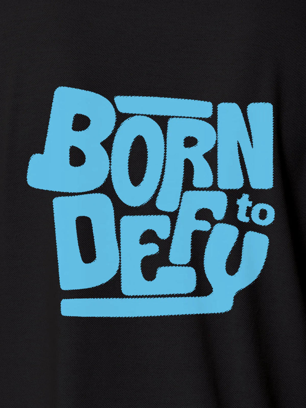 Close up of 'Born To Defy' design on Women's Dark Grey Polo T-shirt, highlighting intricate details and vibrant print.