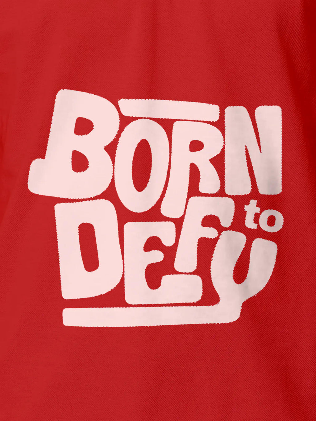 Close up of 'Born To Defy' design on Men's Red Polo T-shirt, highlighting intricate details and vibrant print.