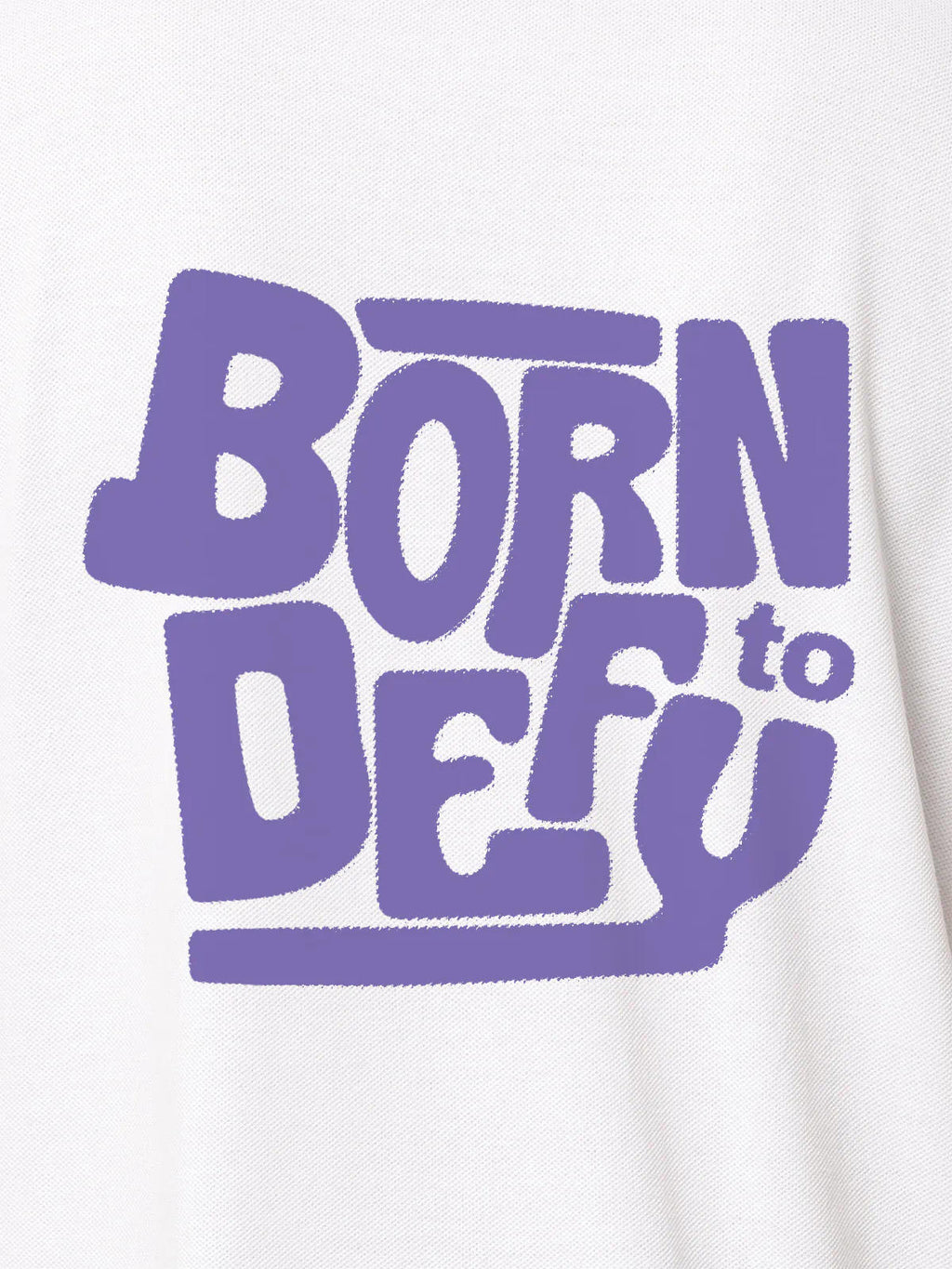 Close up of 'Born To Defy' design on Women's White Polo T-shirt, highlighting intricate details and vibrant print.