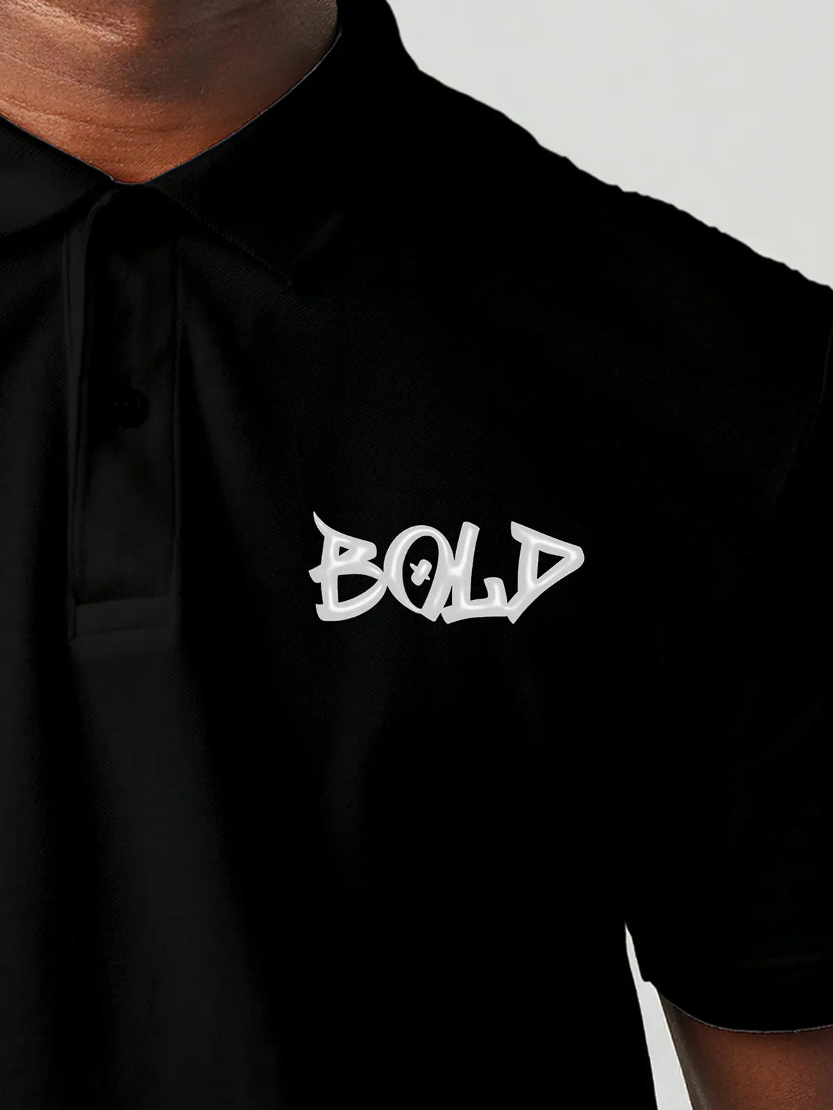 Close up of 'Bold' on Men's Black Polo T-shirt, highlighting intricate details and vibrant print.